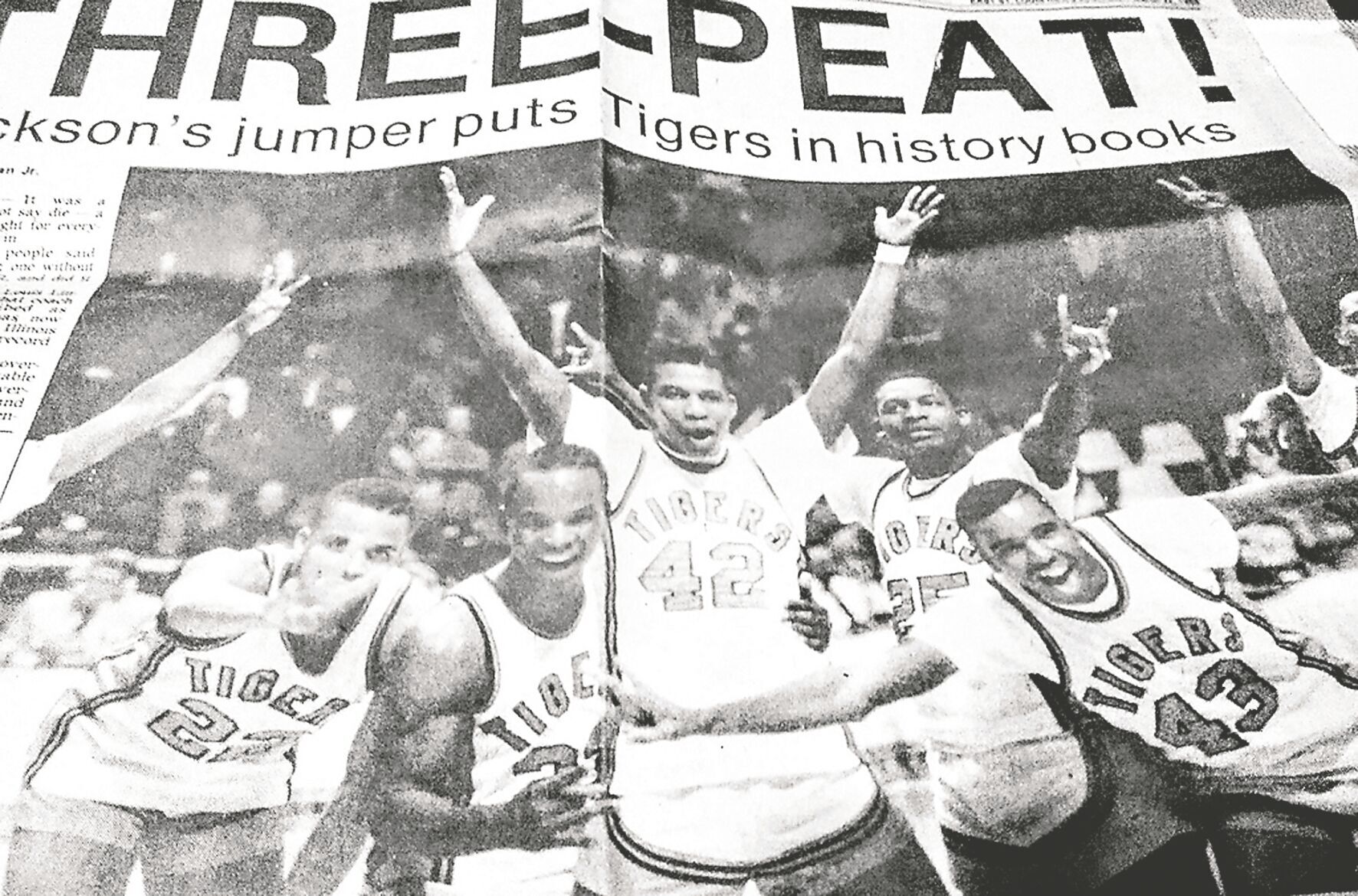 Newspaper photo of the players celebrating after the game, with the headline ‘Three-Peat.’